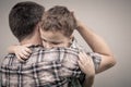 Sad son hugging his dad Royalty Free Stock Photo