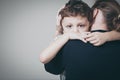 Sad son hugging his mother Royalty Free Stock Photo