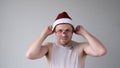 The sad and sorrowful European young man in a New Year's hat looks gloomily into the camera. Royalty Free Stock Photo