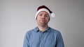 The sad and sorrowful European young man in a New Year's hat looks gloomily into the camera. Royalty Free Stock Photo