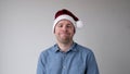 The sad and sorrowful European young man in a New Year's hat looks gloomily into the camera. Royalty Free Stock Photo