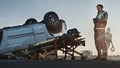 Sad, Sorrowful Paramedic Standing at the Scene of the Terrible Car Crash Traffic Accident. Victims Royalty Free Stock Photo