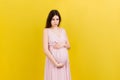 Sad and stressed pregnant woman  on colored background Royalty Free Stock Photo