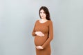 Sad and stressed pregnant woman isolated on colored background Royalty Free Stock Photo