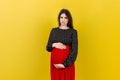 Sad and stressed pregnant woman isolated on colored background Royalty Free Stock Photo