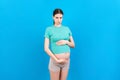 Sad and stressed pregnant woman isolated on colored background Royalty Free Stock Photo