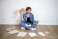 Sad stressed woman with calculator and bank and bills paperwork and documents doing domestic financial accounting