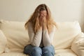 Sad and stressed young woman covering her face with her hands and crying Royalty Free Stock Photo