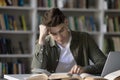 Student guy studying in library feels bored or tired Royalty Free Stock Photo