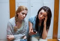 Sad student showing a text message to her friend Royalty Free Stock Photo