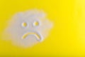 Sad sugar face on the yellow background. Bad food.