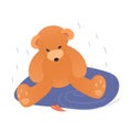 Sad teddy bear in a puddle in the autumn rain