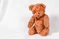 Sad Teddy Bear on white background: old brown toy from last century. Royalty Free Stock Photo