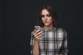 Sad teen being victim of cyber bullying online sitting on a couch in the living room at Royalty Free Stock Photo