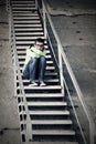 Sad teen boy in depression sitting on steps Royalty Free Stock Photo