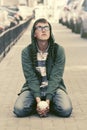 Sad teen boy in depression sitting on sidewalk in city street Royalty Free Stock Photo