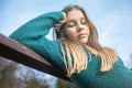 Sad teen girl on a bench in the park. Single girl on a bench Royalty Free Stock Photo