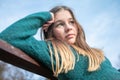 Sad teen girl on a bench in the park. Single girl on a bench Royalty Free Stock Photo