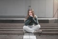 Sad teen girl on a bench in the park. Single girl outdoor. Lonely sad girl Royalty Free Stock Photo