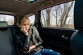 Sad teen girl in seat back of car close his eyes Royalty Free Stock Photo