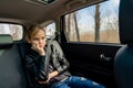 Sad teen girl in seat back of car look ahead Royalty Free Stock Photo