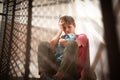 Sad teenage boy sitting on stairs. Bullying at school Royalty Free Stock Photo