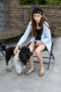 Sad teenage girl is comforted by her little poodle dog Royalty Free Stock Photo