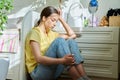 Sad teenage girl sitting on the floor at home Royalty Free Stock Photo