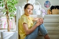 Sad teenage girl sitting on the floor at home Royalty Free Stock Photo