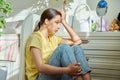 Sad teenage girl sitting on the floor at home Royalty Free Stock Photo