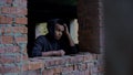 Sad teenager among abandoned house ruins, remembering family and childhood