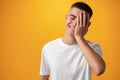Sad teenager boy failed, touching face against yellow background Royalty Free Stock Photo