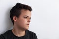 Sad teenager boy looking sideways - propping his head against th Royalty Free Stock Photo