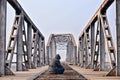 Sad teenager in depression sitting on a bridge at the sunset. Royalty Free Stock Photo