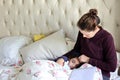 Sad teenager girl lying in bed while her mother  comforting her Royalty Free Stock Photo