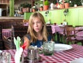 Sad teenager girl in a restaurant. Lonely girl waiting in a caffee Royalty Free Stock Photo