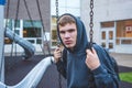 Sad teenager sitting on a swing.