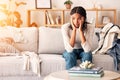 Sad, thinking and black woman with depression on sofa in home. Mental health, anxiety and female from Nigeria on couch Royalty Free Stock Photo