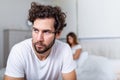 Sad thoughtful man after arguing with girlfriend.Relationship difficulties, conflict and family concept,unhappy couple having Royalty Free Stock Photo