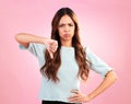 Sad, thumb down and portrait of a woman in a studio with an upset, moody or disappointed face. Loser, unhappy and young