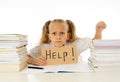Sad tired and angry blonde school girl holding help sign in stress doing homework and studying with books in children education Royalty Free Stock Photo