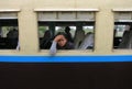 A sad and tired Burmese girl looking out of the window of an old train