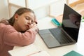 Sad tired european teenager girl doing homework, sleeping near computer with empty screen Royalty Free Stock Photo