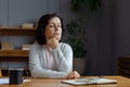 Sad tired ill sick lonely disappointed older senior woman sitting at home alone. Unhappy mature grandmother experiencing Royalty Free Stock Photo