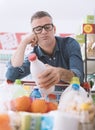 Sad man doing grocery shopping Royalty Free Stock Photo