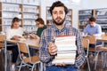 Sad tired man sitting in library Royalty Free Stock Photo