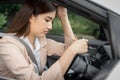 Sad and tired young Asian female office worker sitting in her car thinking of problems at work Royalty Free Stock Photo