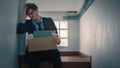 Sad unhappy businessman losing job sit on the stairs and hold the document box is placed on the knee., Business failure and laid