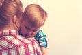 Sad unhappy child hugging his mother Royalty Free Stock Photo