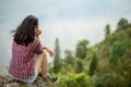 Sad unhappy depressed girl sitting on the top of the mountain Royalty Free Stock Photo